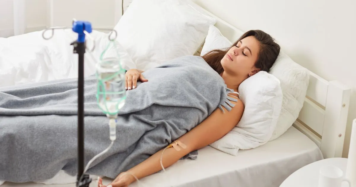 Woman receiving IV Hydration Therapy in bed in Miami Lakes, FL